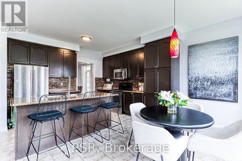 A modern kitchen with a bar area and a dining table set up.