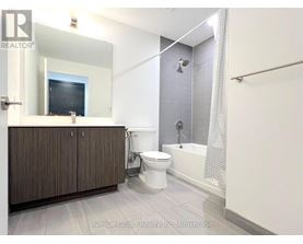 A bathroom with a toilet, sink, and bathtub.