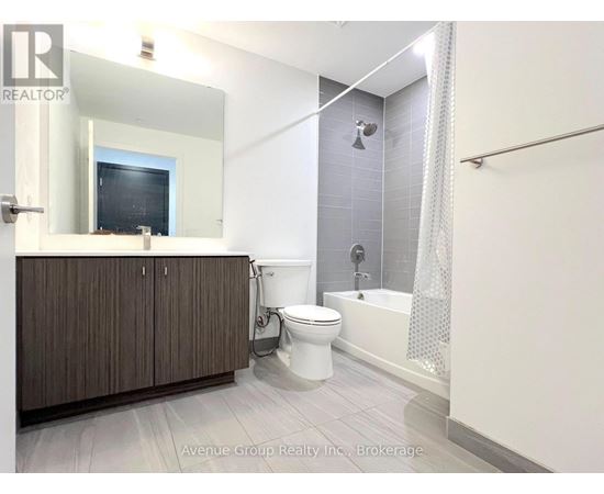 A bathroom with a toilet, sink, and bathtub.