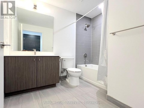 A bathroom with a toilet, sink, and bathtub.