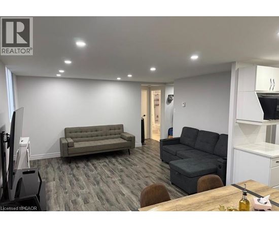 A living room with a grey couch and a wooden table.