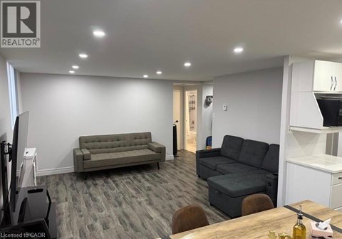 A living room with a grey couch and a wooden table.