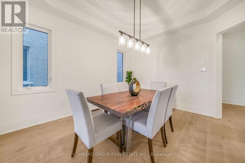 A dining room with a wooden table and grey chairs.