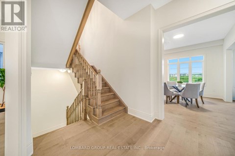 A spacious room with a staircase and a dining table.