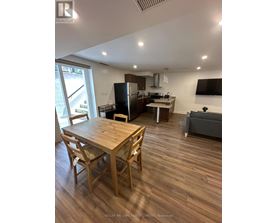 A well-lit kitchen with a dining table and chairs.