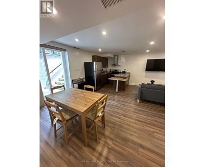 A well-lit kitchen with a dining table and chairs.