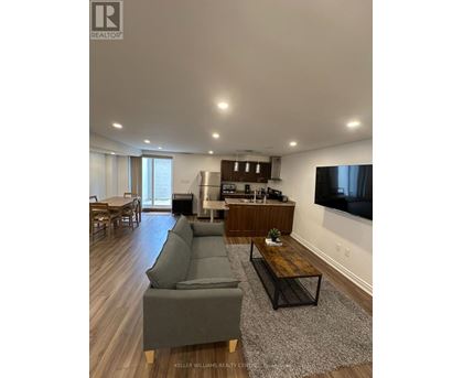 A modern living room with a grey sofa and a wooden coffee table.