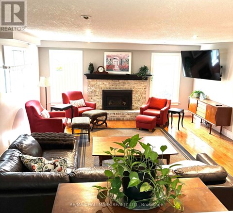 A living room with a fireplace and a TV mounted on the wall.