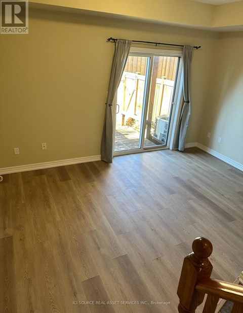 A room with a sliding glass door leading to a balcony.
