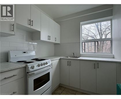 A kitchen with white appliances and cabinets.