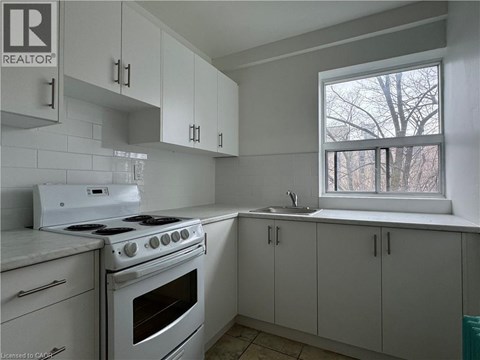 A kitchen with white appliances and cabinets.