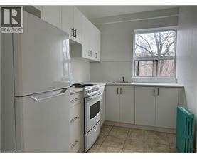 A kitchen with white appliances and cabinets.