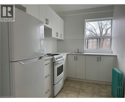 A kitchen with white appliances and cabinets.