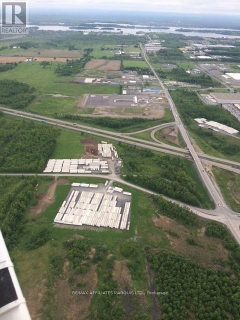 A bird's eye view of a large open field with a building complex in the middle.