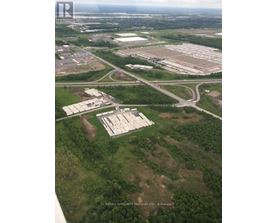 An aerial view of a large property with a sign that reads "Resinix Affiliate Manorous Ltd Brokerage".