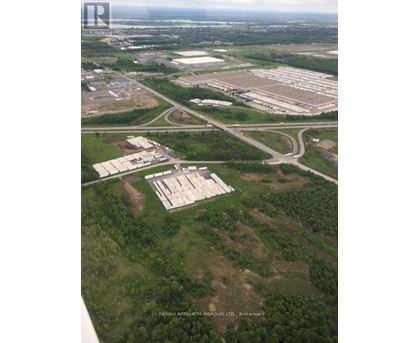 An aerial view of a large property with a sign that reads "Resinix Affiliate Manorous Ltd Brokerage".