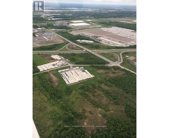 An aerial view of a large property with a sign that reads "Resinix Affiliate Manorous Ltd Brokerage".