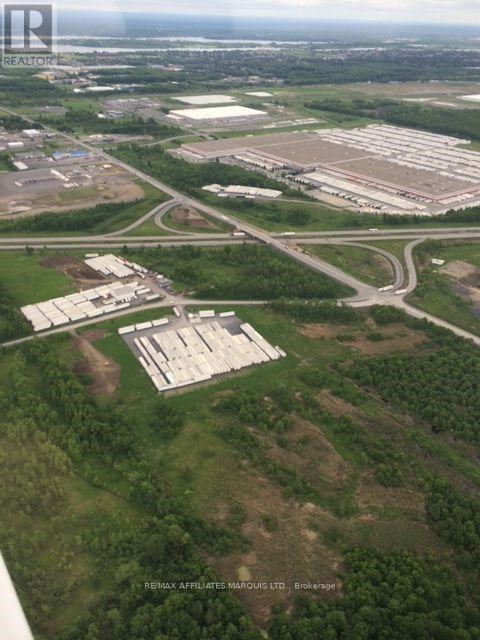 An aerial view of a large property with a sign that reads "Resinix Affiliate Manorous Ltd Brokerage".