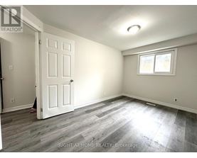 A room with a white door and a window with a white frame.