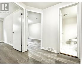 A white bathroom with a toilet and a sink.