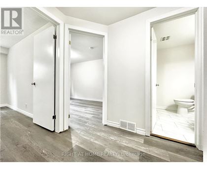 A white bathroom with a toilet and a sink.