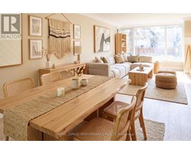 A well-lit, modern dining room with a wooden table and chairs.