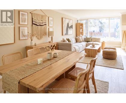 A well-lit, modern dining room with a wooden table and chairs.