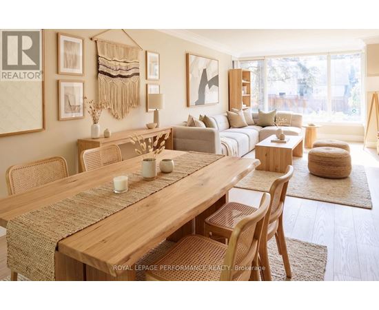 A well-lit, modern dining room with a wooden table and chairs.