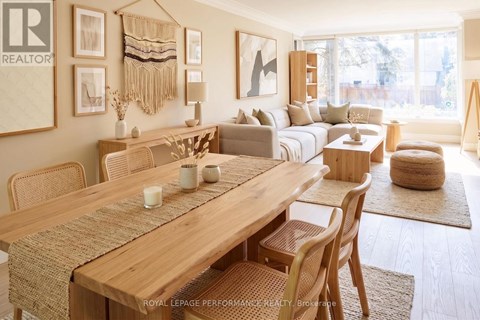 A well-lit, modern dining room with a wooden table and chairs.