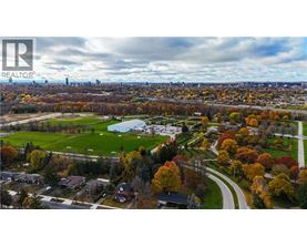 A realtor logo is on a picture of a suburban neighborhood.