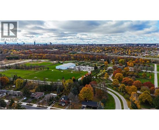 A realtor logo is on a picture of a suburban neighborhood.