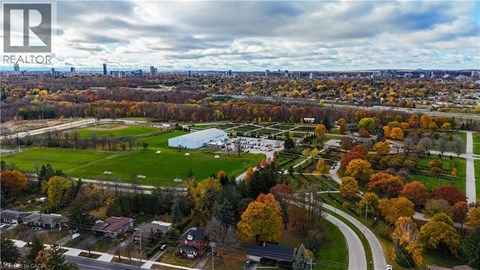 A realtor logo is on a picture of a suburban neighborhood.