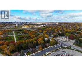 An aerial view of a residential area with a realtor logo in the corner.