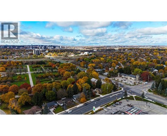 An aerial view of a residential area with a realtor logo in the corner.