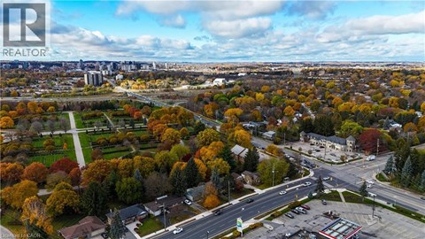 An aerial view of a residential area with a realtor logo in the corner.