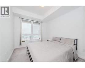 A bedroom with a large bed and a window with a view.