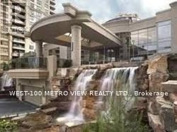 A waterfall in front of a building with the text "WEST-100 METRO VIEW REALTY LTD., Brokerage".