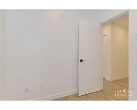 A white door is in a room with white walls.