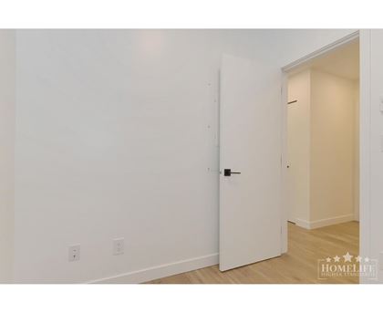 A white door is in a room with white walls.