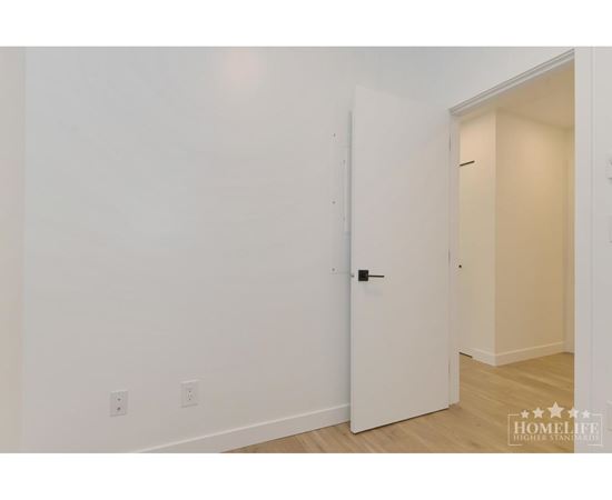 A white door is in a room with white walls.