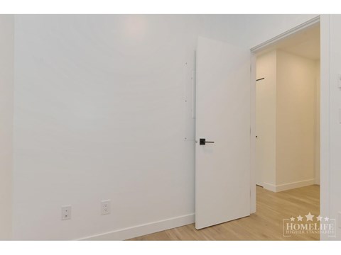 A white door is in a room with white walls.