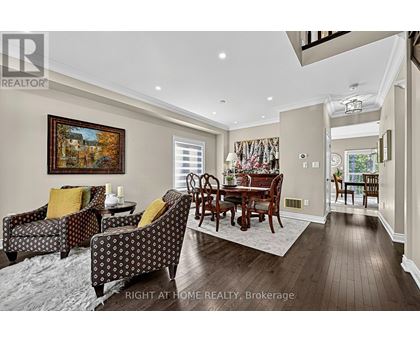 A living room with a brown wooden table and chairs.