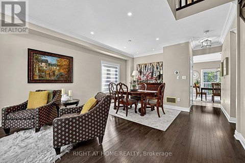 A living room with a brown wooden table and chairs.