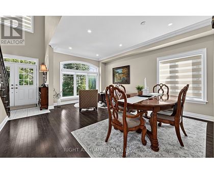 A dining room with a wooden table and chairs.