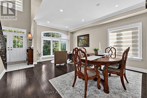 A dining room with a wooden table and chairs.