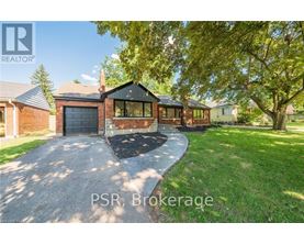 A residential property with a driveway and a garage is for sale.