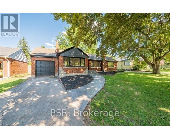 A residential property with a driveway and a garage is for sale.