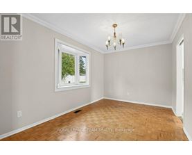 A room with a wooden floor and a chandelier.