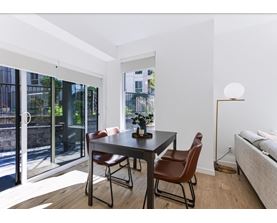 A modern dining room with a table and chairs.