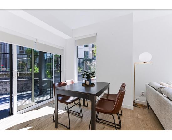 A modern dining room with a table and chairs.